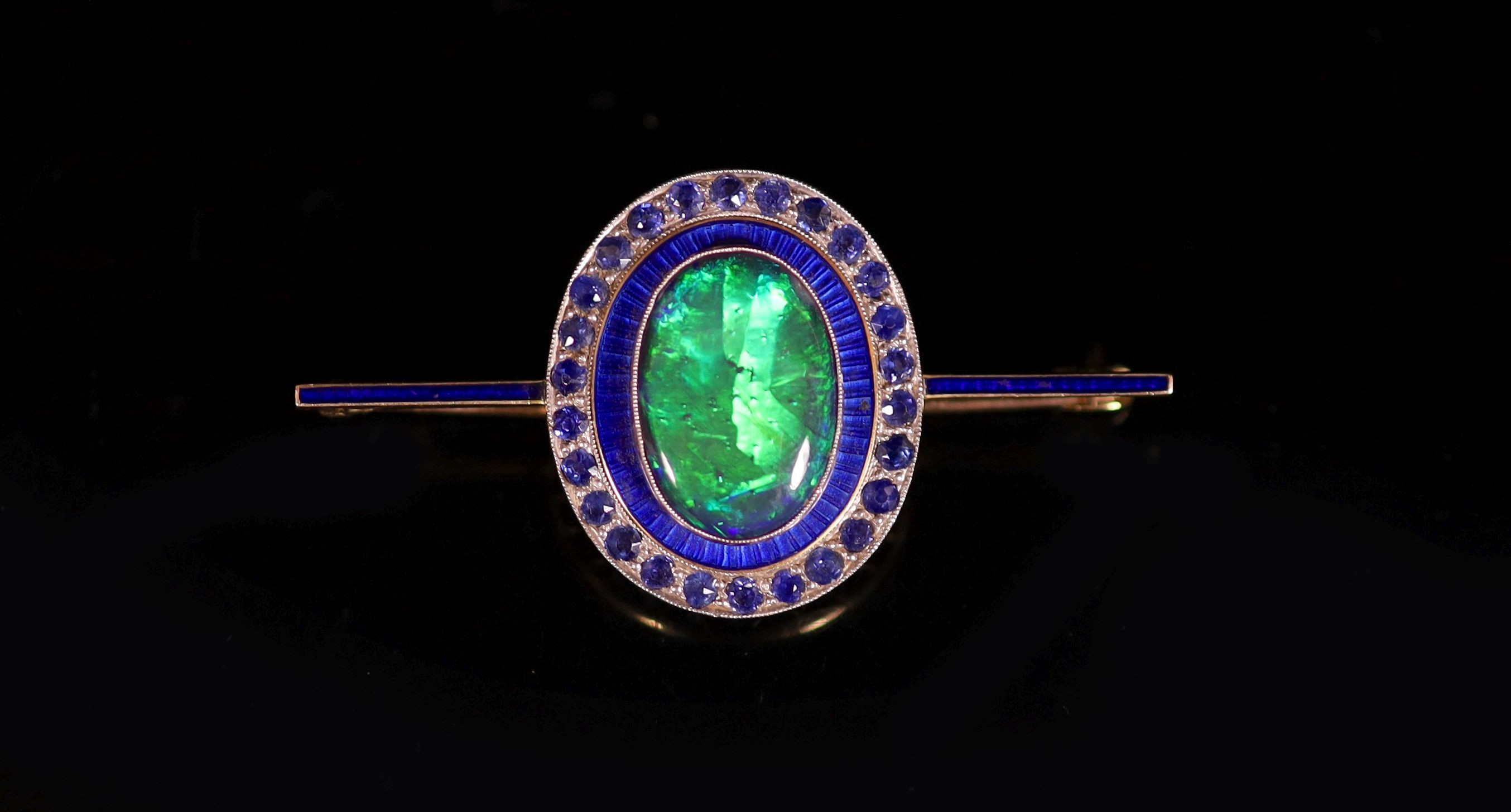 An early to mid 20th century gold, black opal doublet, blue enamel and millegrain sapphire set bar brooch